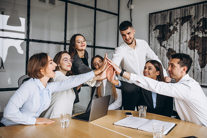 Business team collaborating around a laptop in a meeting room
